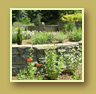Curving stone walls create terraced flower beds