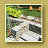 Stone staircase beside flower beds and winding stone paths