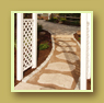 Stone path goes through a white arched arbor