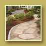 Curving stone and sand pathway winds through flower beds